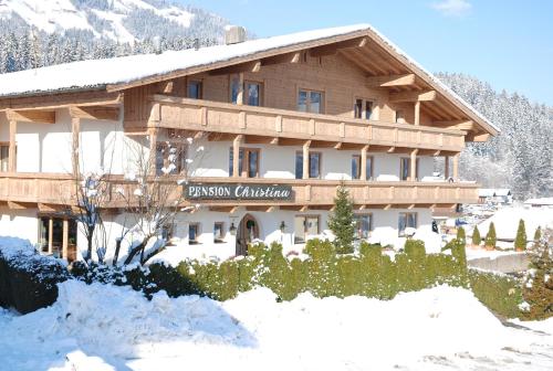 a large wooden building with snow on it at Sportpension Christina by PiaundDirk in Fügen
