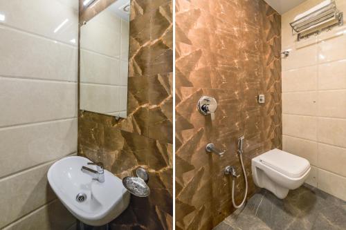 Hotel Sea Grand, Colaba في مومباي: حمام مع حوض ومرحاض ودش