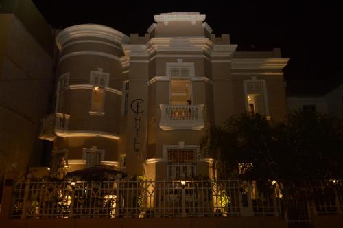 a large building with a clock on the front of it at Casa Falleri Boutique Hotel in Lima
