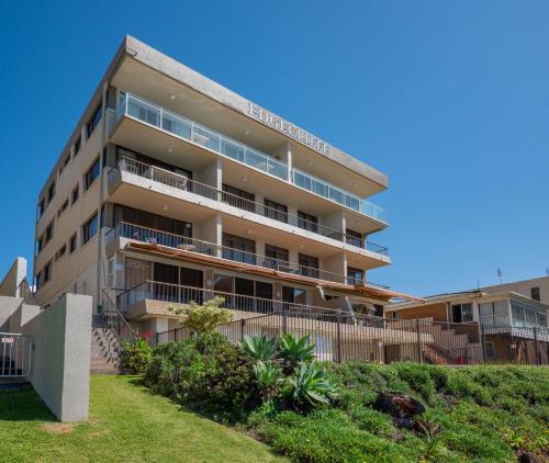 an apartment building with balconies and a yard at Edgecliffe Unit 4 4 Esplanade Kings Beach in Caloundra