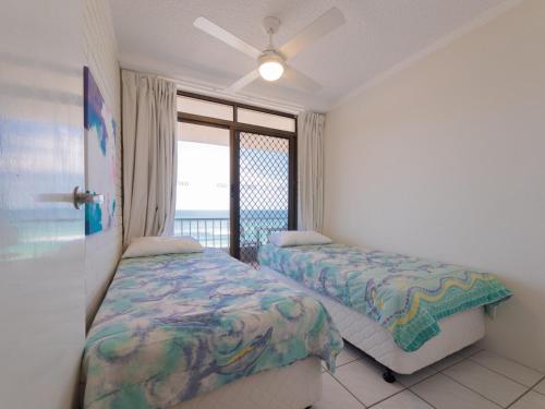 a bedroom with two beds and a window at Edgecliffe Unit 4 4 Esplanade Kings Beach in Caloundra