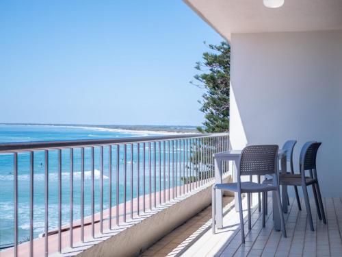 two chairs and a table on a balcony overlooking the ocean at Edgecliffe Unit 4 4 Esplanade Kings Beach in Caloundra