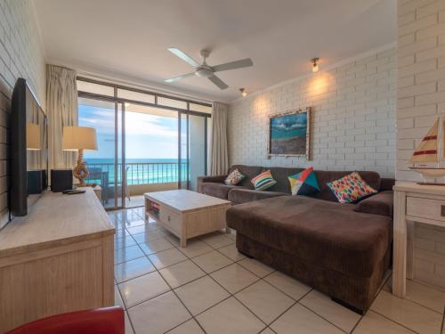 a living room with a couch and a flat screen tv at Edgecliffe Unit 4 4 Esplanade Kings Beach in Caloundra