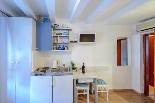 a kitchen with a sink and a table at Studio Stradun in Dubrovnik