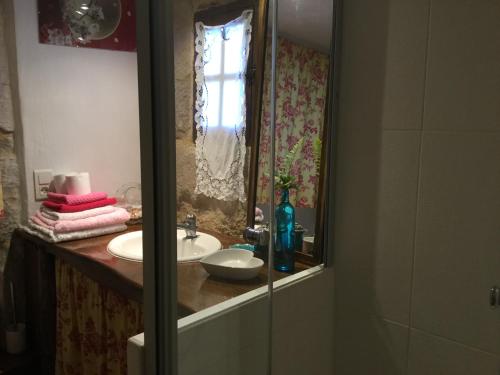 a bathroom with a sink and a mirror at Ombre & Fraîcheur in Cazals