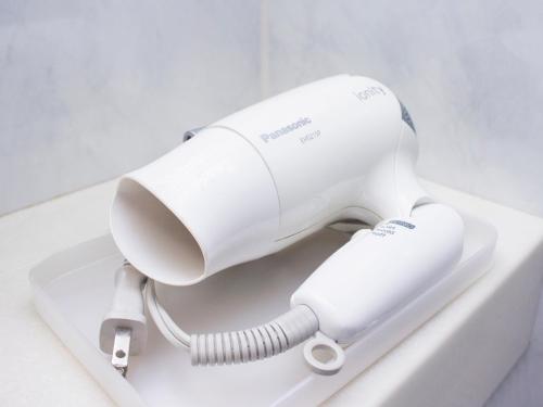 a white hairdryer sitting on top of a sink at Hearton Hotel Kita Umeda in Osaka