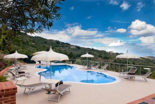 a swimming pool with patio furniture and umbrellas at Casa Vacanza Villa Aurora in Laureana Cilento