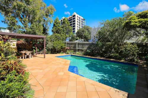 a swimming pool in the middle of a yard at Eastbourne U4 80 Esplanade Golden Beach in Caloundra