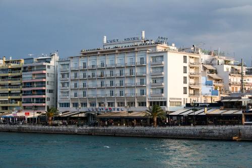 a large white building next to a body of water at Lucy Hotel in Chalkida