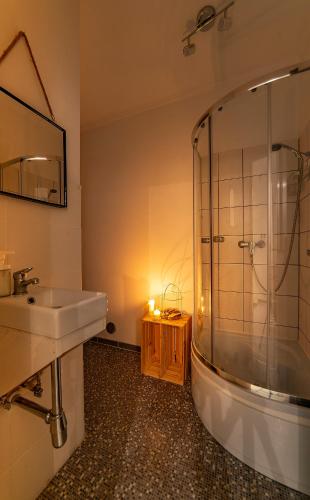 a bathroom with a sink and a shower at Hostel PrzyMorze in Gdańsk