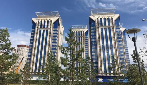 three tall buildings with trees in front at Однокомнатная квартира в ЖК Millennium Park in Astana