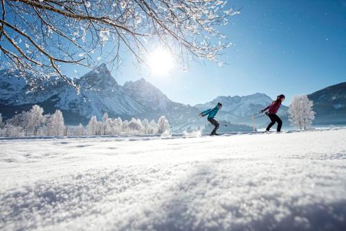 two people cross country skiing in the snow at Mellow Mountain Hostel in Ehrwald