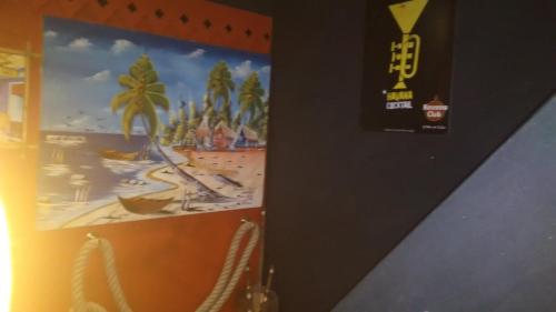 a poster of a beach on a wall at Apartment Cuba Zen Actitud in Mouscron