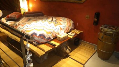 a bed in a room with a table next to it at Apartment Cuba Zen Actitud in Mouscron