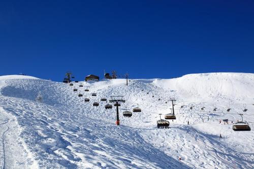 a snow covered ski slope with a ski lift at Hotel Dorfer in Grossarl