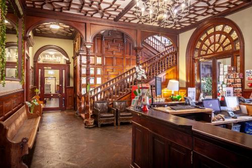 a bar in a room with a staircase in a building at Palmers Lodge Swiss Cottage in London
