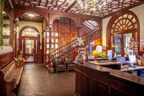 - un bar dans une pièce avec un escalier dans un bâtiment dans l'établissement Palmers Lodge Swiss Cottage, à Londres