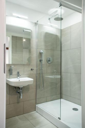 a bathroom with a shower and a sink at Pałac w Małkowie in Warta