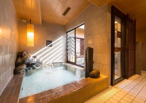 a large indoor pool in a building at Dormy Inn Premium Tokyo Kodenmacho in Tokyo
