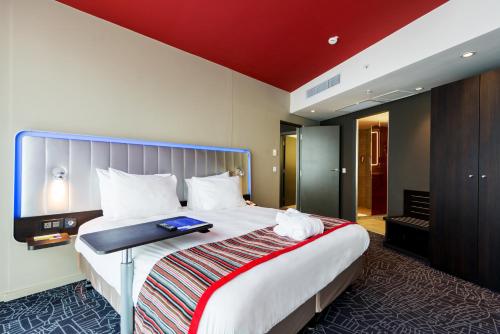 a hotel room with a bed with a book on it at Park Inn by Radisson Libreville in Libreville