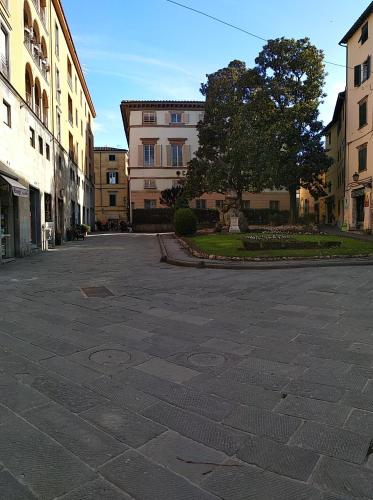 an empty parking lot in a city with buildings at da Francesco rooms in Lucca