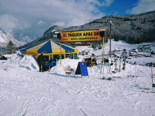 a yellow and blue tent on a snow covered slope at Pension Edelweiss Top 25 in Gosau
