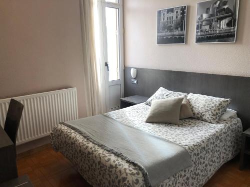a bedroom with a bed with two pillows on it at Hotel Ripa in Bilbao