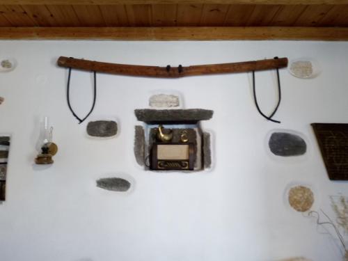 a camera hanging on a wall with rocks at Traditional house paros in Sarakíniko