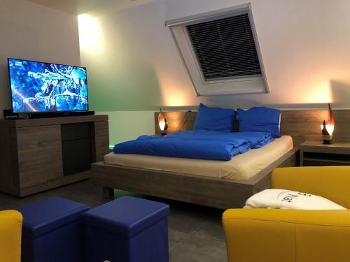 a bedroom with a bed and a flat screen tv at B&B wellness Sea Nat voor Naturisten in Oostduinkerke