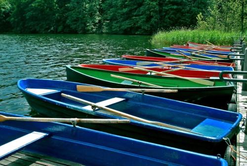 a row of boats tied to a dock on a lake at Feriendomizile Korswandt in Korswandt