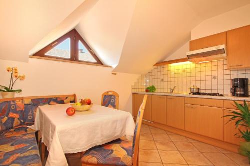 a kitchen with a table with a bowl of fruit on it at Schmözlhof in Tesido