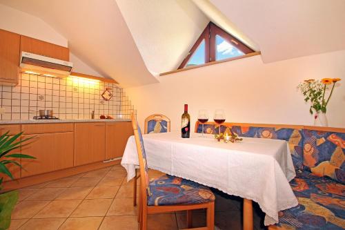 a kitchen with a table with two glasses of wine at Schmözlhof in Tesido