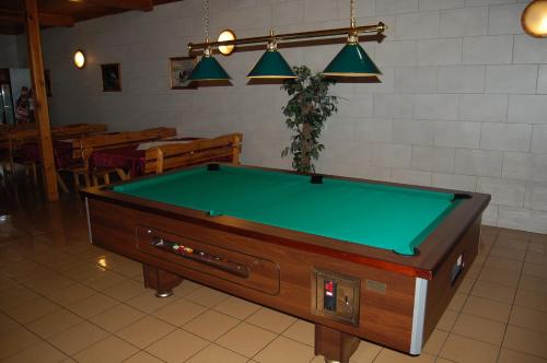 a pool table sitting in a room with at Inter-Bar-Motel in Nowe Marzy