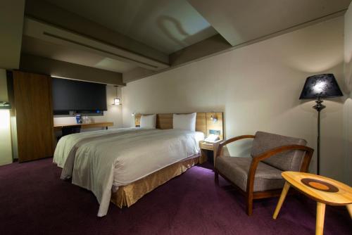 Un ou plusieurs lits dans un hébergement de l'établissement Simple + Hotel