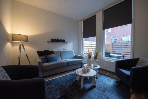 a living room with a couch and a table at Flonk Hotel Groningen Centre, BW Signature Collection in Groningen