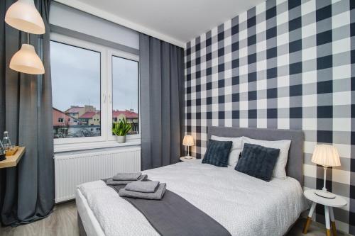 a hotel room with a large bed and a large window at Królewiecka 115 in Elblag