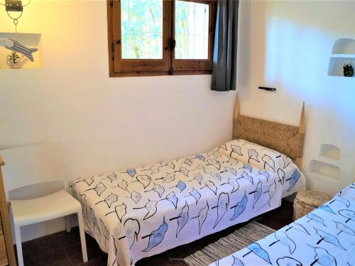 a bedroom with two beds and a window at Cirici in Lloret de Mar