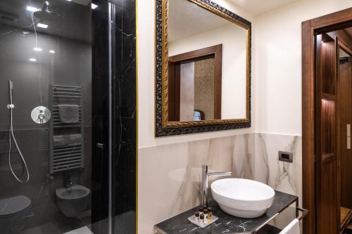 a bathroom with a sink and a shower and a mirror at Palazzo San Lorenzo in Venice