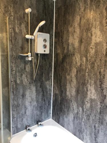 a bathroom with a sink and a concrete wall at 11 Llainwen Isaf in Llanberis