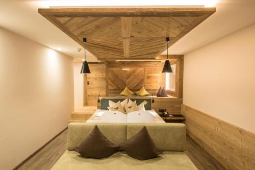 a bedroom with a large bed and wooden walls at Hotel Magdalena im Zillertal - Urlaub mit Hund in Ried im Zillertal