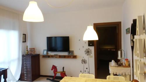 a living room with a flat screen tv on the wall at Holiday Home Bergamo 1 in Bergamo