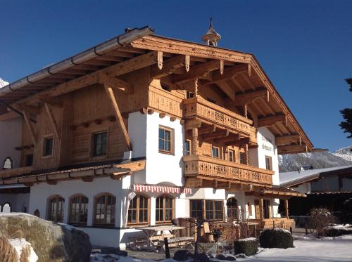 a large wooden house with a steep roof at Landhaus Schwarz in Mieming