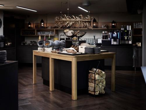a kitchen with a wooden table with dishes on it at Lapland Hotels Bulevardi in Helsinki