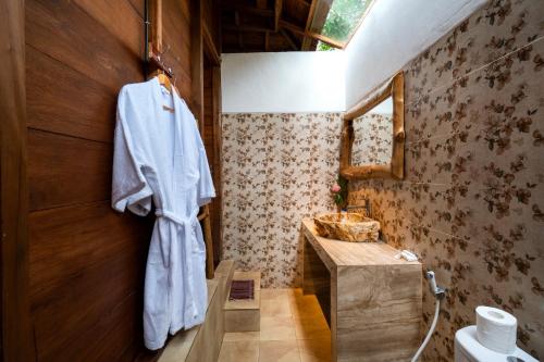 a bathroom with a towel hanging on a wall at Radiance Sunset Villas Lembongan in Nusa Lembongan