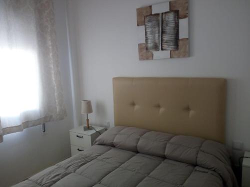a bedroom with a bed and a window at APARTAMENTO PUERTA SEVILLA in Carmona