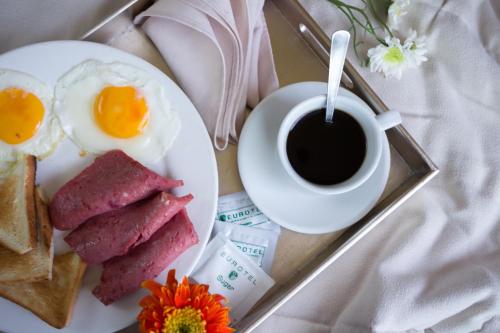 a plate of breakfast food with a cup of coffee at Eurotel Angeles in Angeles