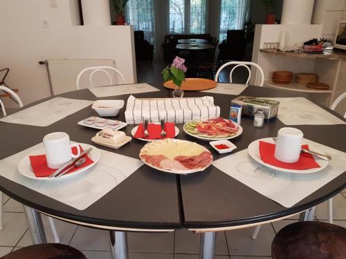 a table with plates of food on top of it at Fertődi Kúria Vendégház in Fertőd