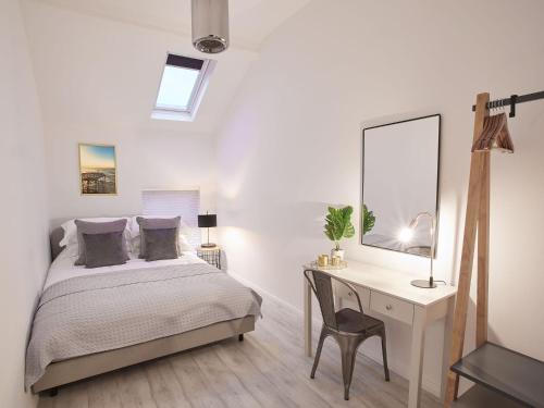 a bedroom with a bed and a desk with a mirror at Host & Stay - The Surfer's Loft Apartment in Saltburn-by-the-Sea