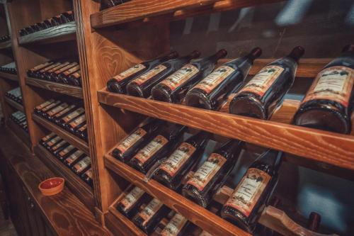 a bunch of bottles of wine in a cabinet at Apartments "Old house Pajovic" in Virpazar
