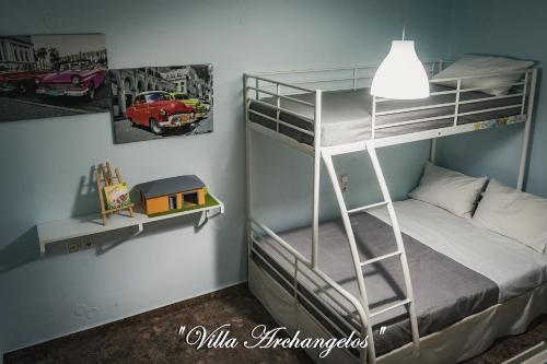 a bedroom with a bunk bed with a ladder at Villa Archangelos in Archángelos